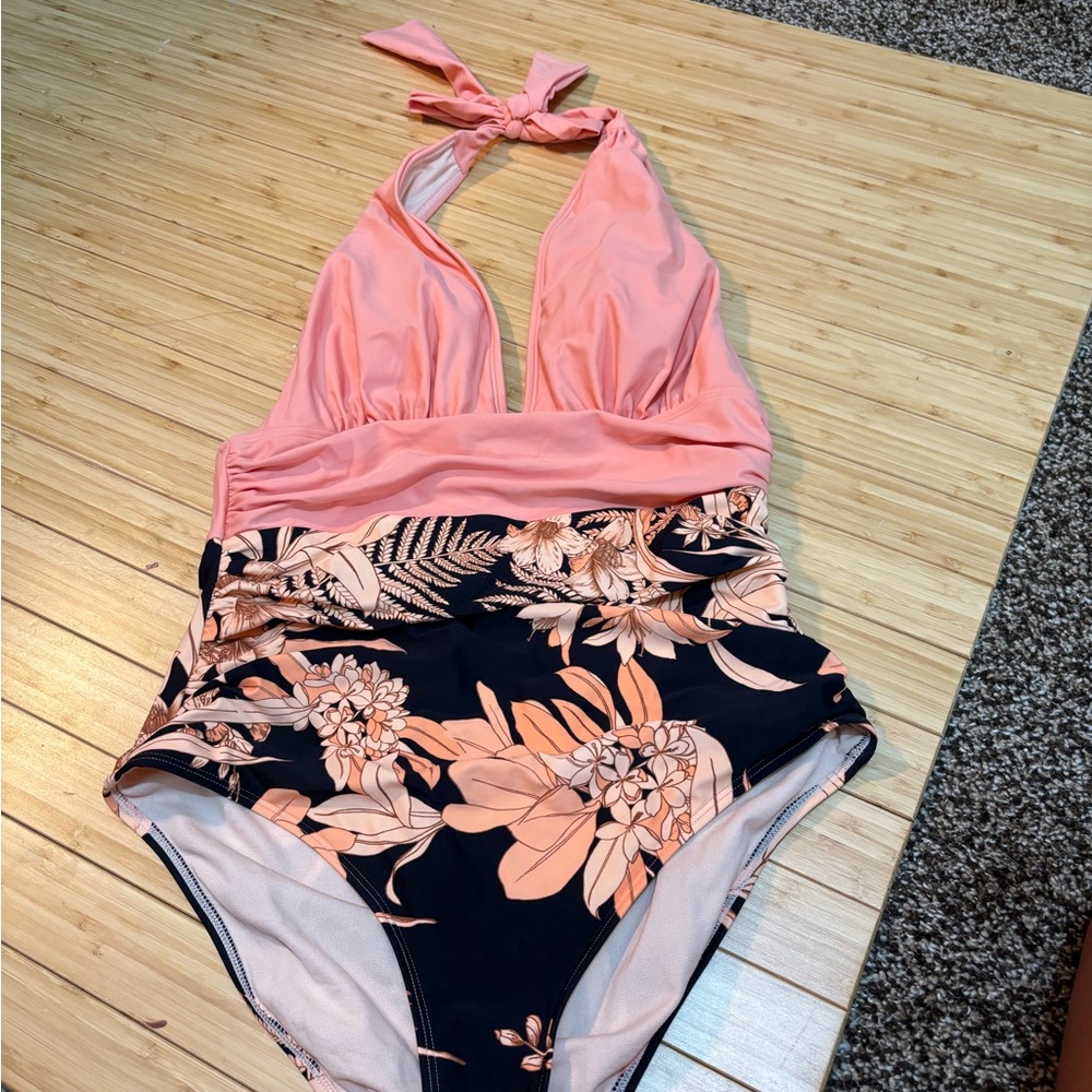 Halter neck one piece ruched swim suit. NWOT. Size M. Black and coral.